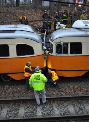 Trolleys collide: Workers inspect the damage. Photo by Bill Forry